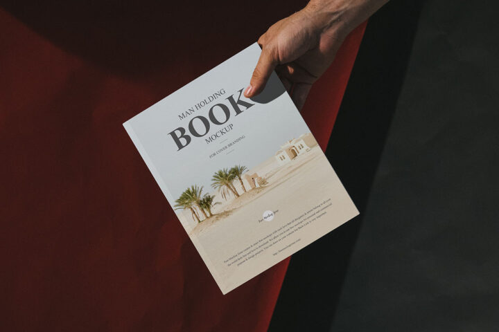 Man Holding Book – Free Mockup